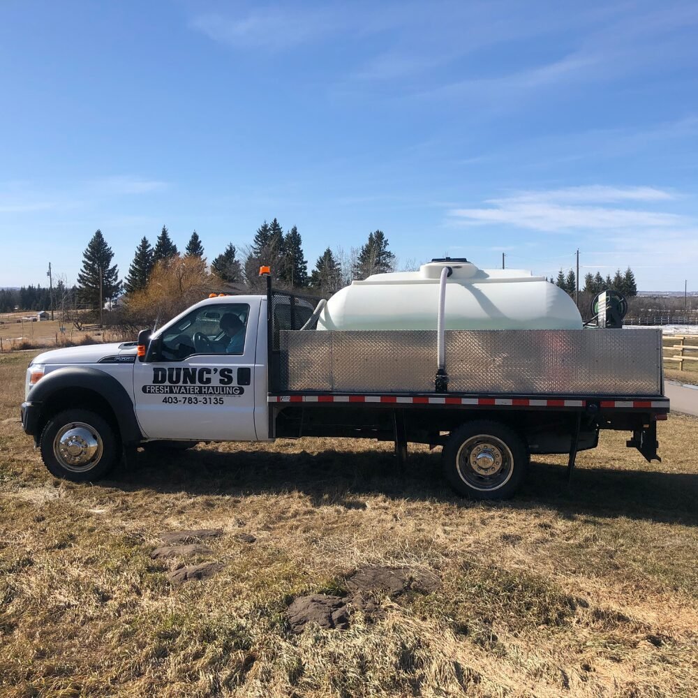 Side view of Dunc’s fresh water delivery truck in Ponoka area